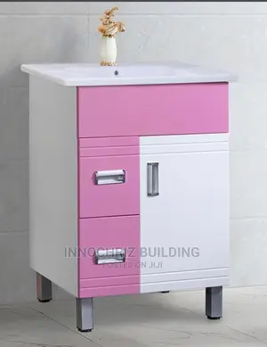 Pink And White Cabinet And Basin