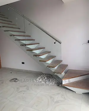 Steel Spine Stairs With Clear Glass And Wooden Slab
