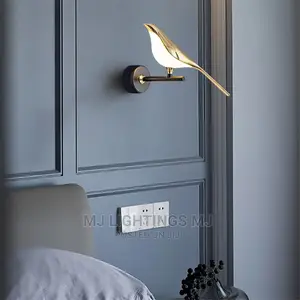 Gold LED Magpie Bird Wall Lamp Beside Hanging Light.