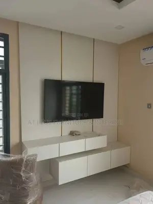 White Tv Wall Panel With 2 Step Console and Touch of Gold
