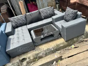 A Standard Grey Sofa With Center Table