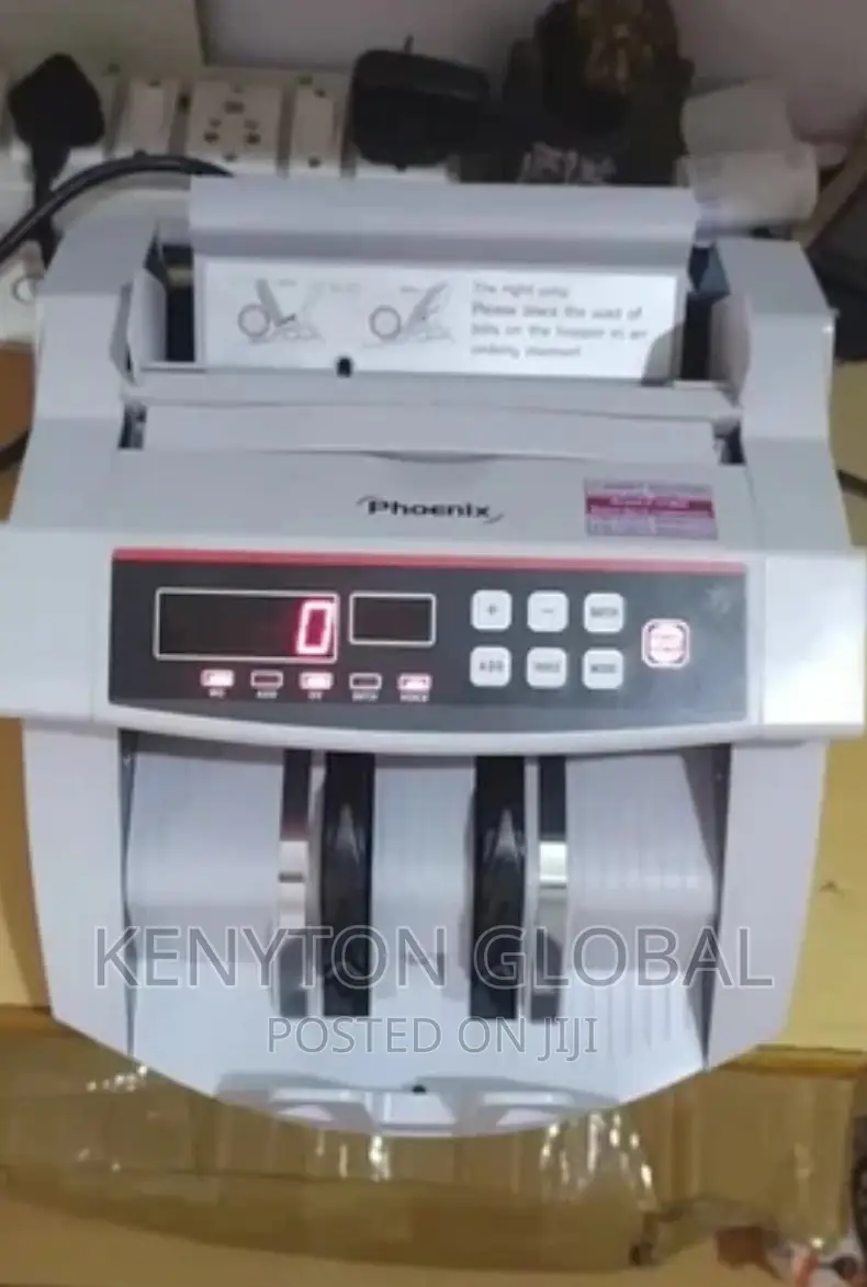 Counting Machine With Automatic Counterfeit Detector