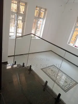 Living Room Glass Staircase With Black Top Rail.