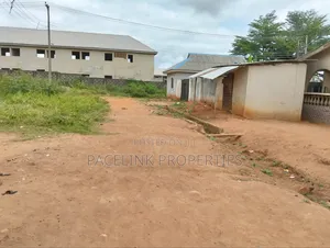 Half Plot of Land With Two Shops