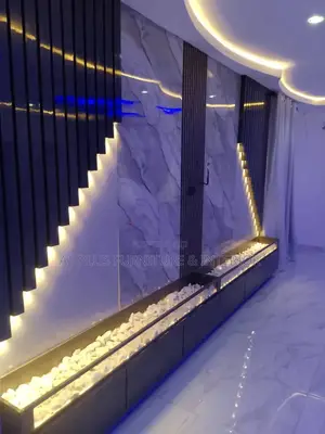 Wall Cladding With Spotlights and Stone Accents