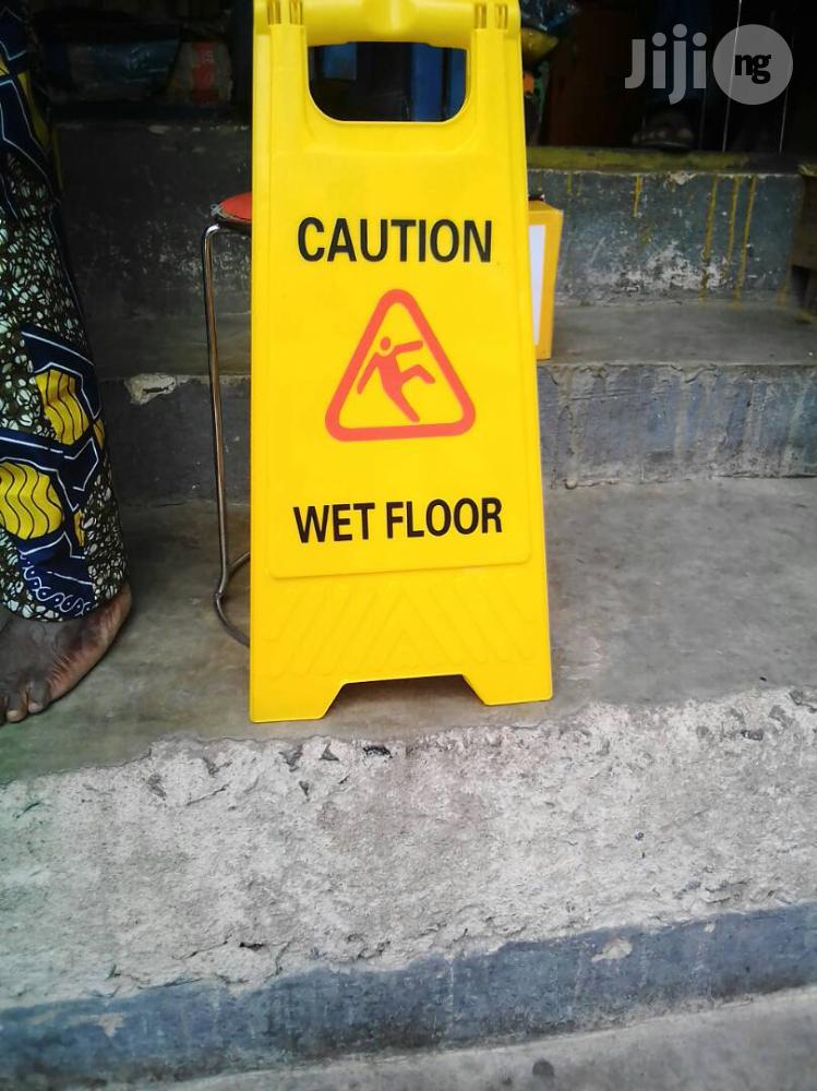 Caution Tapes And Wet Floor Signs
