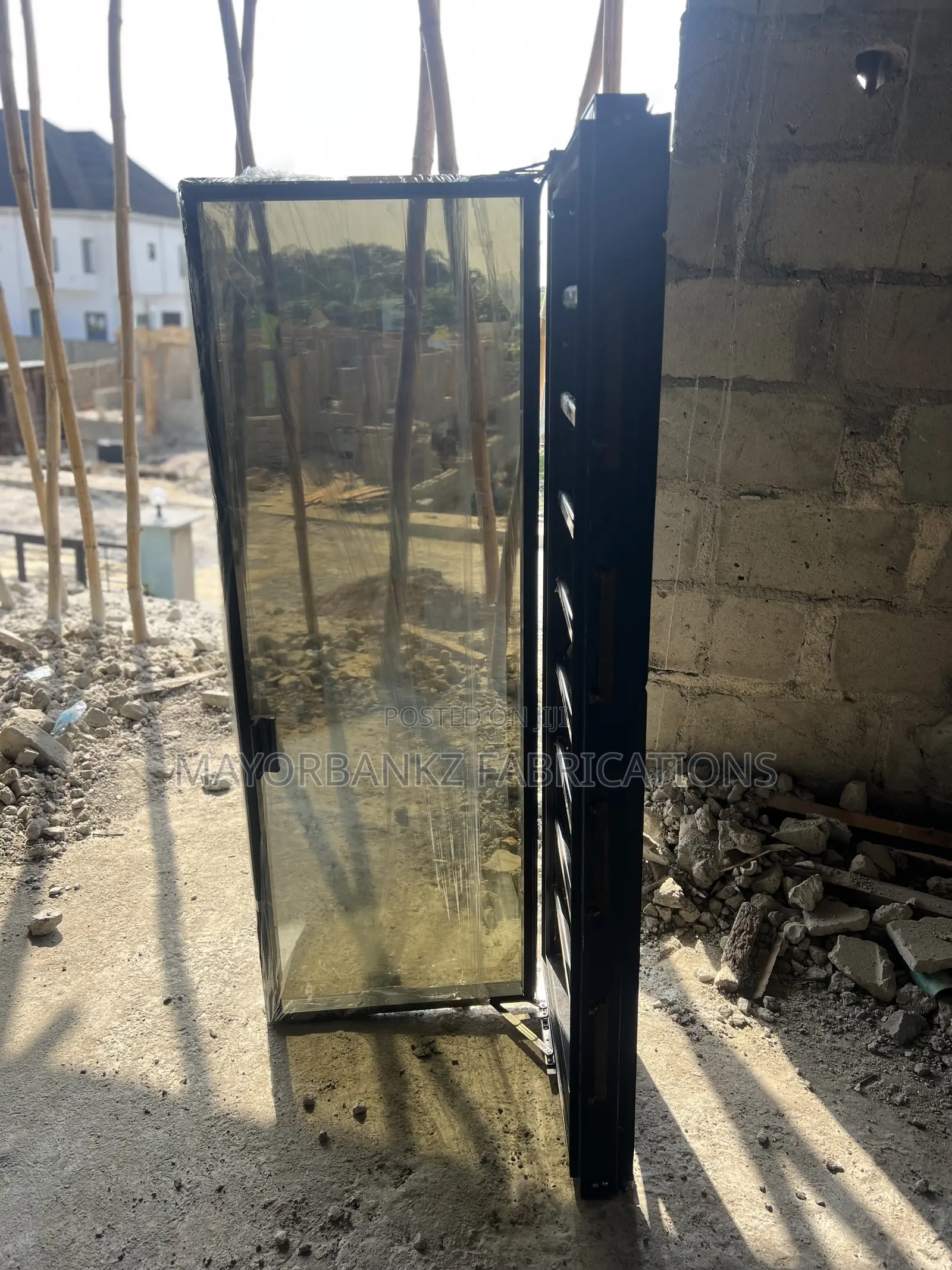 Frameless Window With Black Profile And Gray Glass