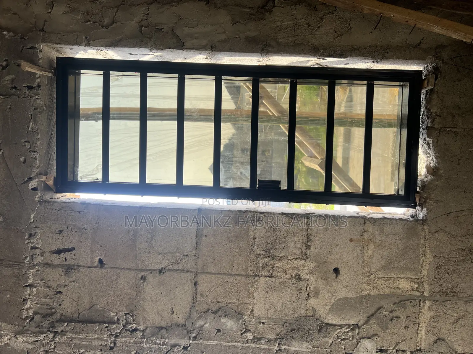 Frameless Window With Black Profile And Gray Glass