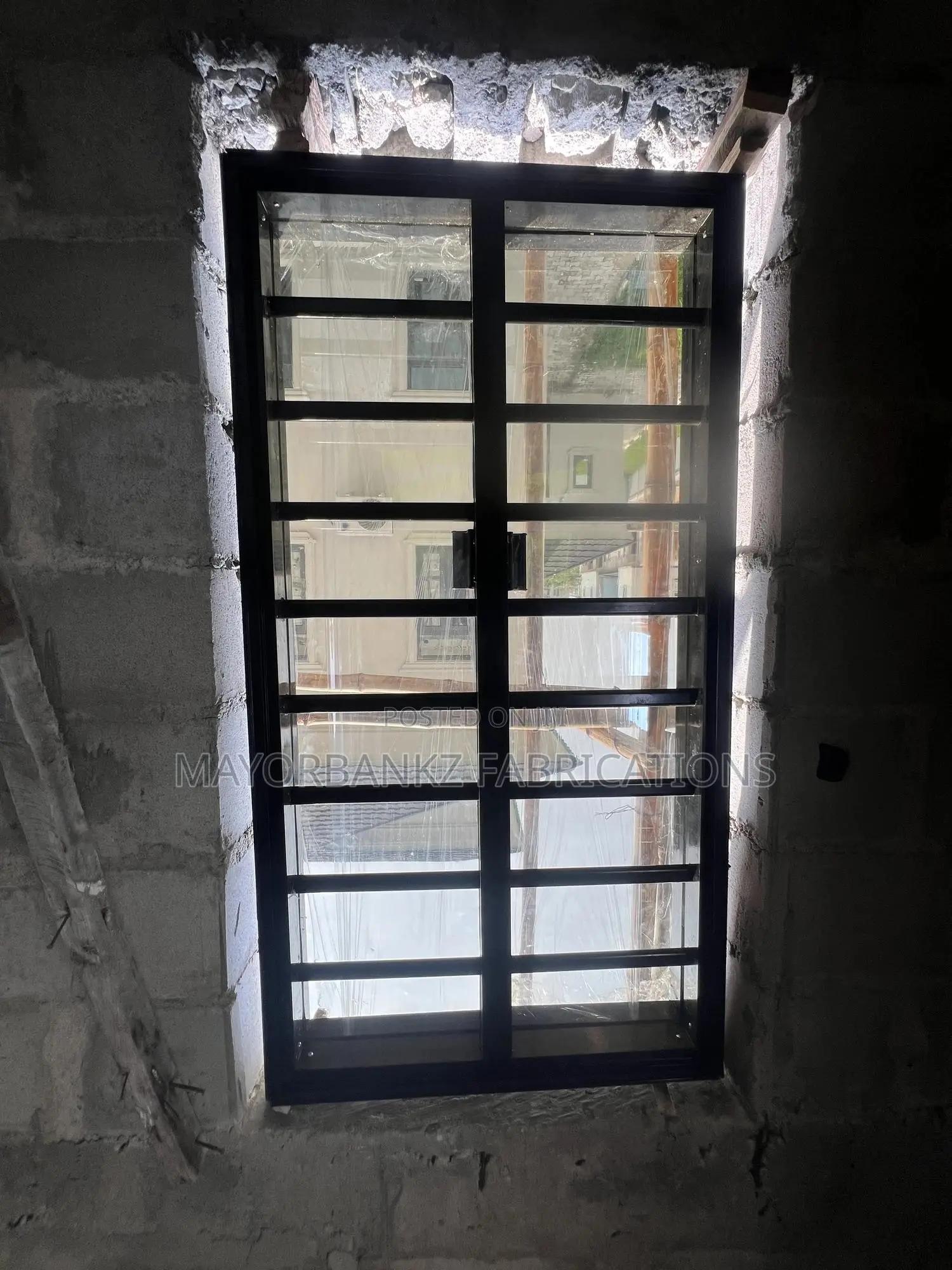 Frameless Window With Black Profile And Gray Glass
