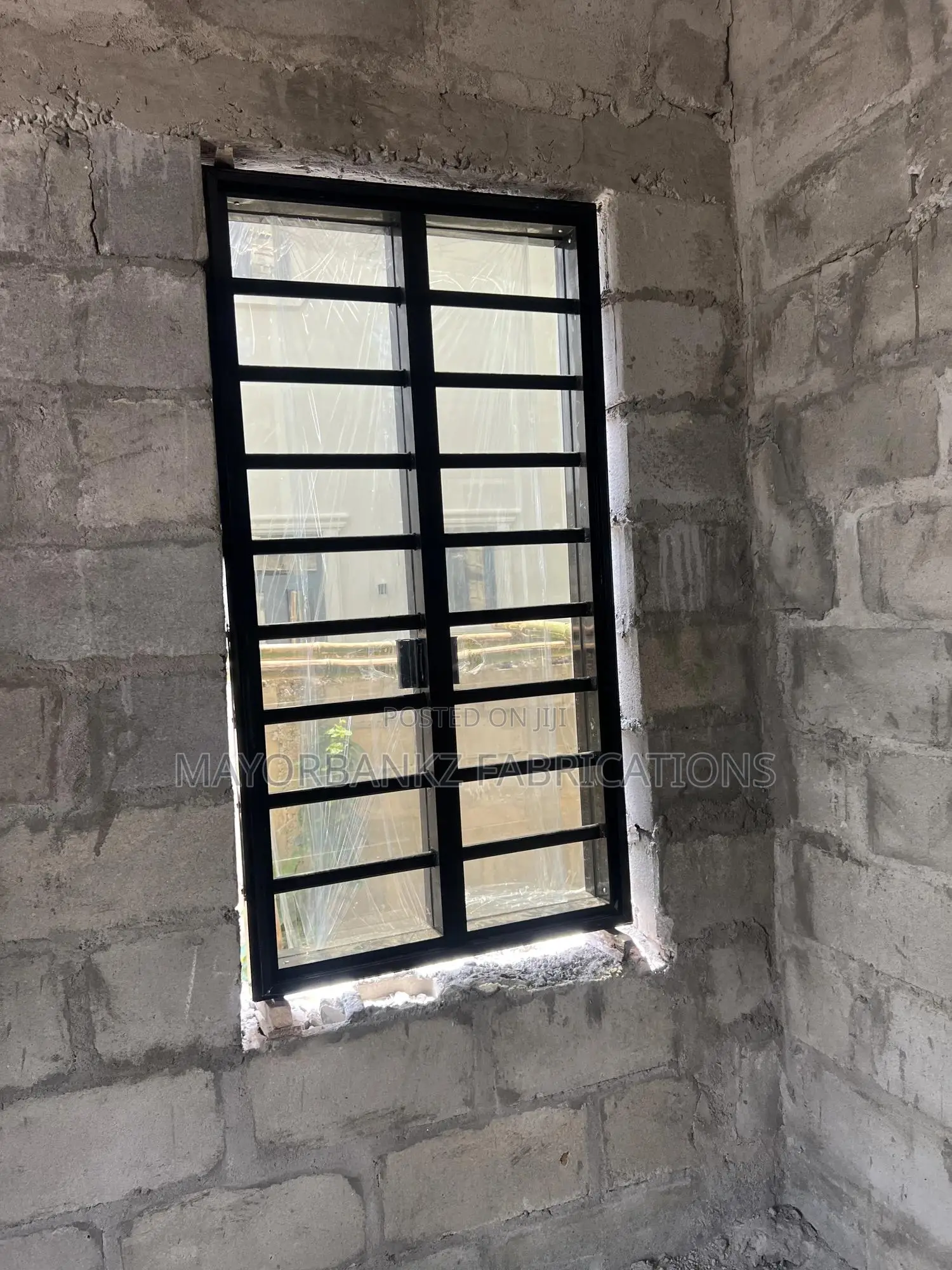 Frameless Window With Black Profile And Gray Glass