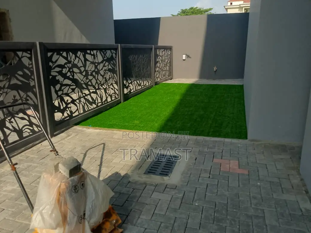 Artificial Grass Next to Real Grass Green