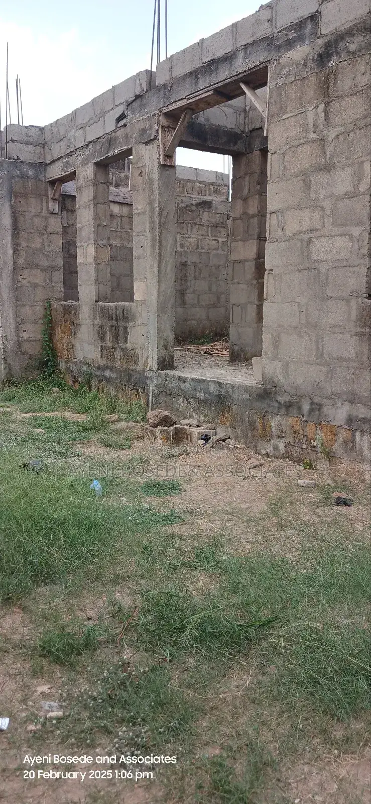 Two Buildings One Completed And The Other At Lintel Level