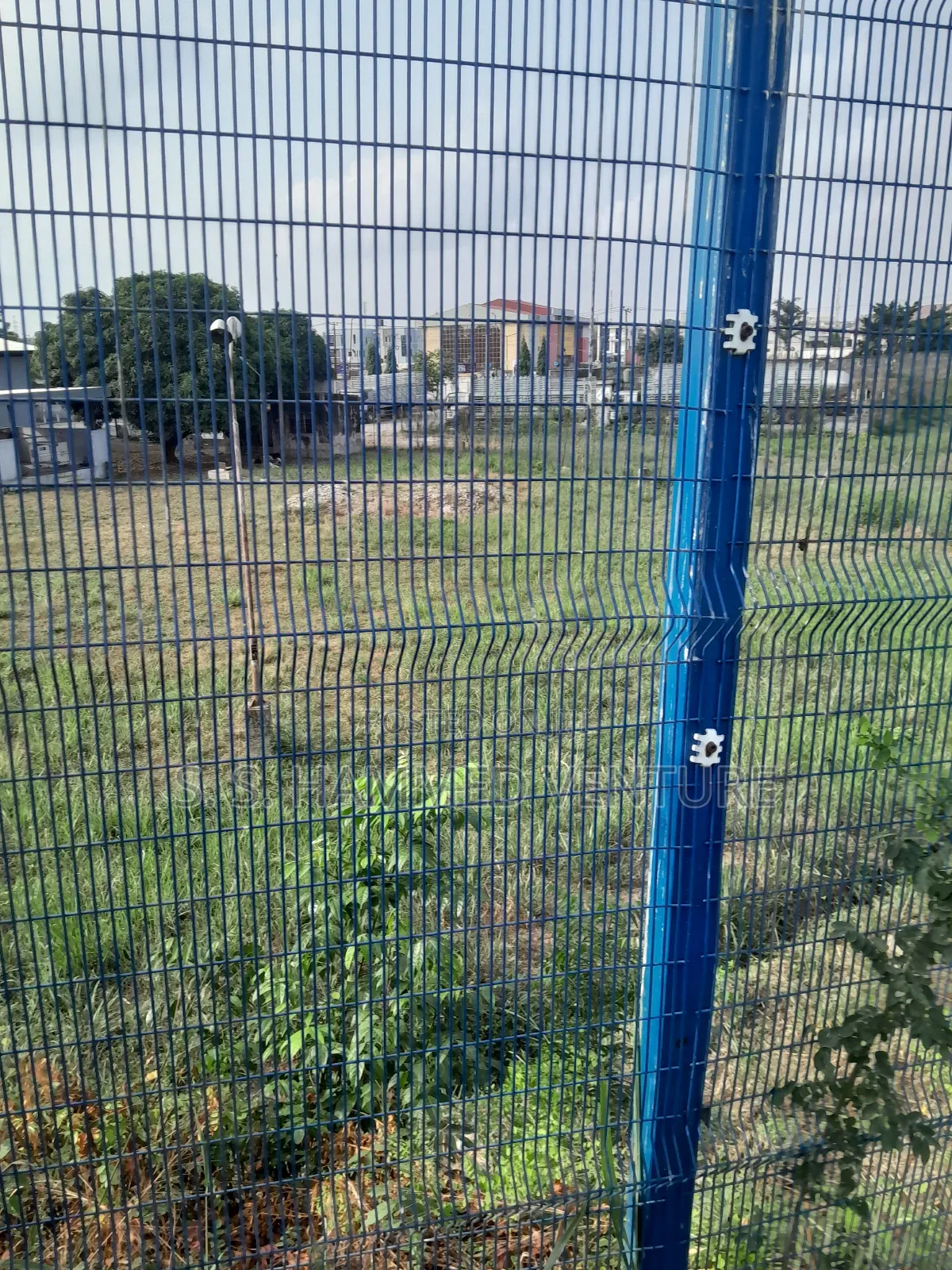 Complex Fencing Seen Through Mesh Wires