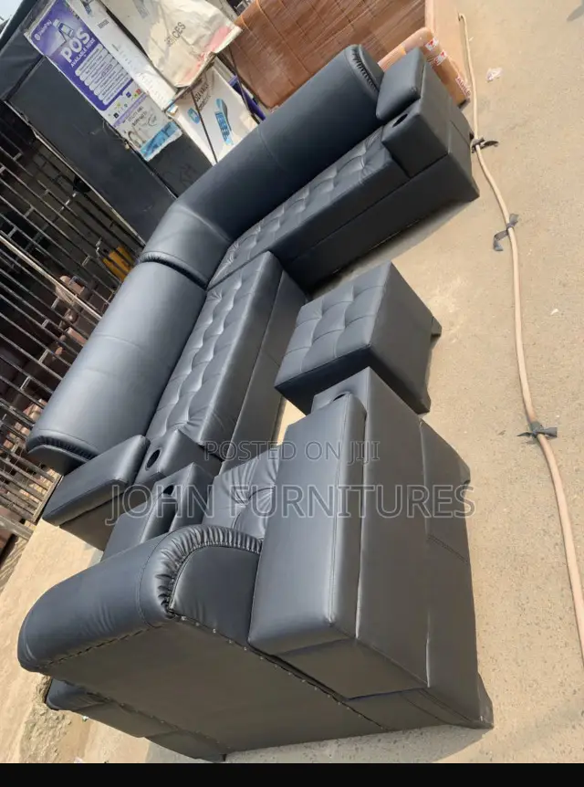Black L Shaped Leather Sofa With a Single Center Table