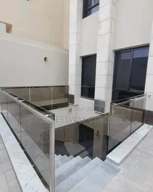 Tinted Glass Railing With Silver Pipe Handle