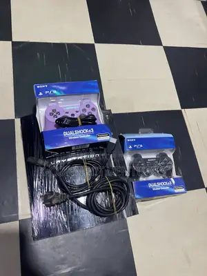 Photo - Playstation 3 With Games Inside and Two Pads
