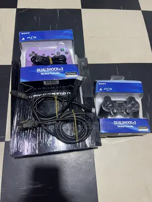 Photo - Playstation 3 With Two Pads and Games Installed Inside