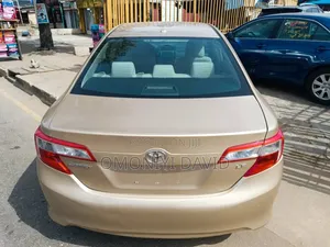 Photo - Toyota Camry LE 4dr Sedan (2.5L 4cyl 6A) 2012 Gold