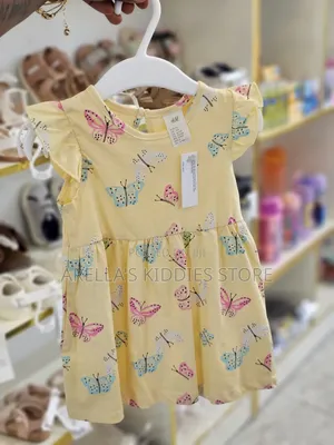 H M Printed Cotton Dress in Yellow With a Butterfly Print.