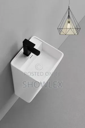Square-shaped, Wall- Hung Basin With A Black Faucet.