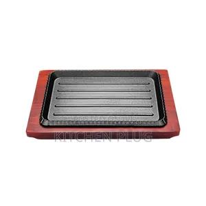 Cast Iron Sizzling Hot Plate With a Wooden Base.