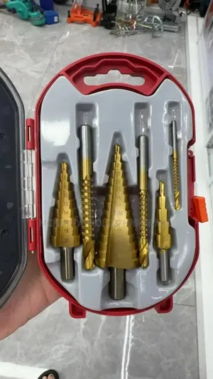 Set Of Step Drill Bits In A Red Case. Step Drill Bits Are