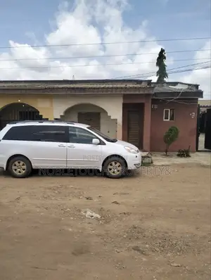 Dry Table Land With 4-Shops at Oluwaga Ipaja Ayobo Lagos