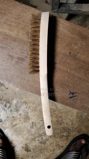 Wire Brush With Brass Bristles And A Wooden Handle.