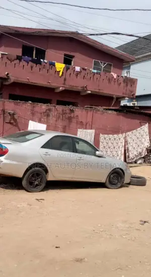 A Land With Old Storey Building in Magodo for Urgent Sale.