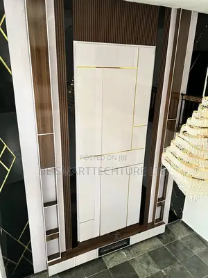 Double-Height Tv Wall Console With Integrated Paneling Gold Accents