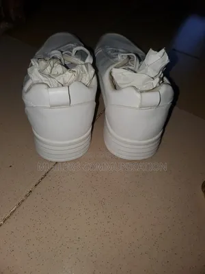 A Pair of White Casual Sneakers for Sale