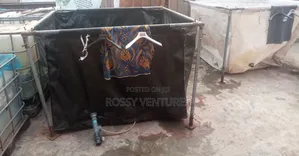 Tarpaulin and White Tank for Fish Pond