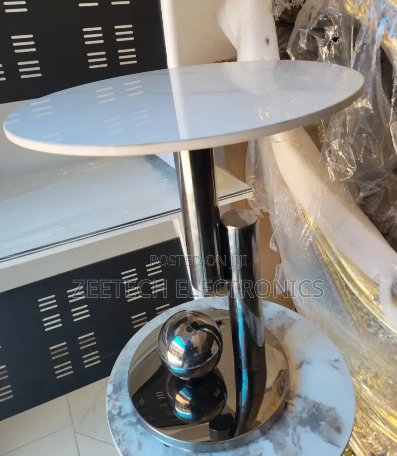Round Side Table With a White Marble Top and a Polished Stainless Stee
