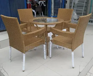 Black Rattan Outdoor Dining Set With a Glass-Top Table and Four Armcha