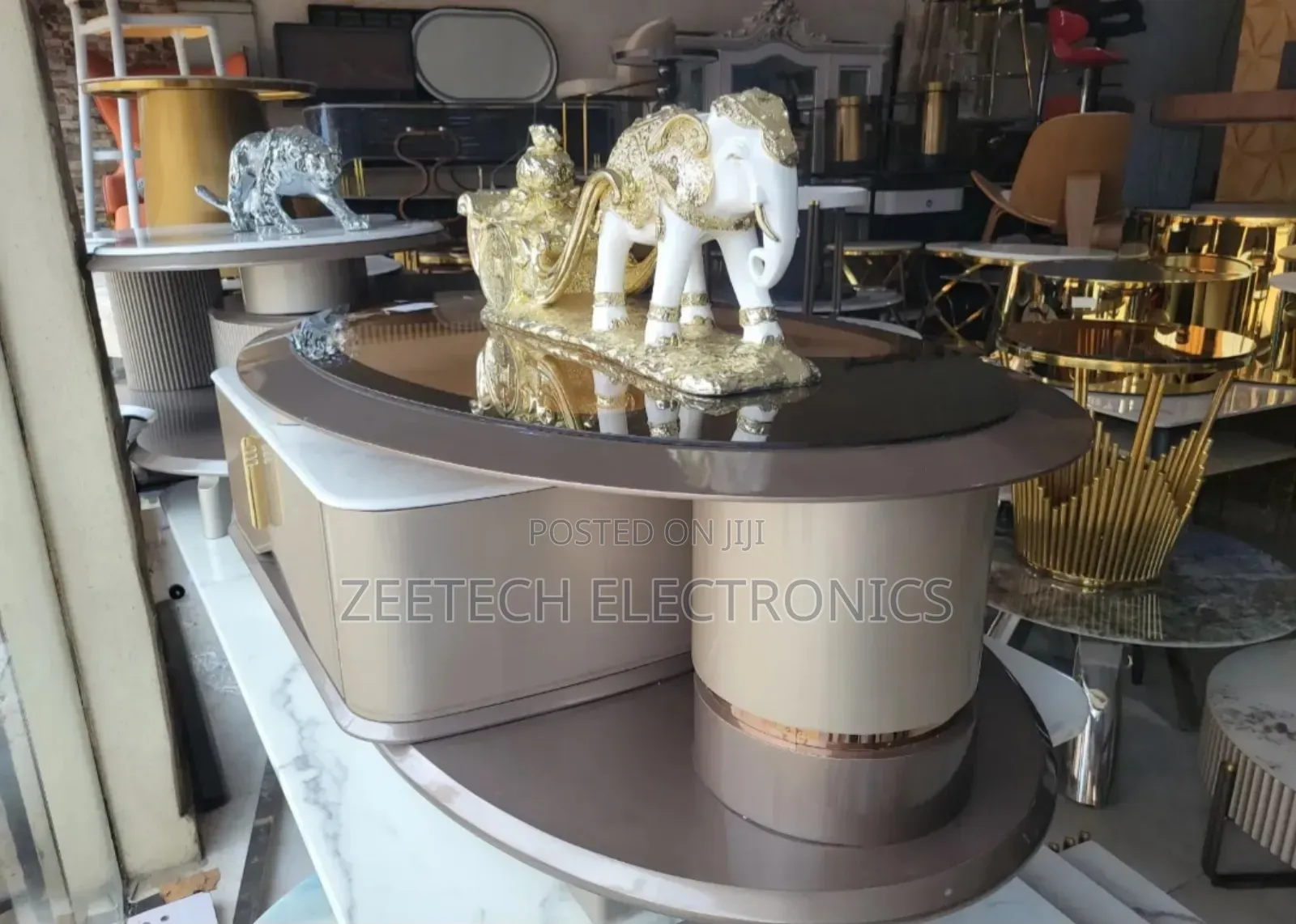 Modern, Oval-Shaped Coffee Table With a Glossy, a Mirrored Top.