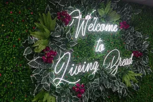 Custom Neon Sign Design With Floral Backdrop Installation