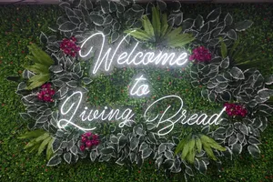 Custom Neon Sign Design With Floral Backdrop Installation