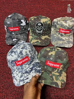 *Balenciaga the Simpsons Cap and *Supreme Stone Camo Cap* 