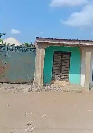 A Plot of Land Fenced With Gate, With 5 Shops.