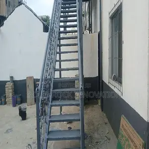Metal Staircase With Wrought Iron Railing