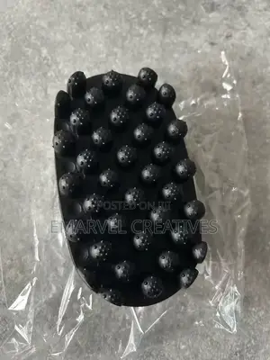 A Black Hairbrush Featuring A Twisted Afro Comb,