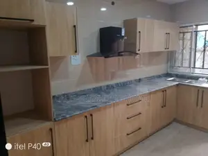 L - Shape Kitchen Cabinets Brown Color.