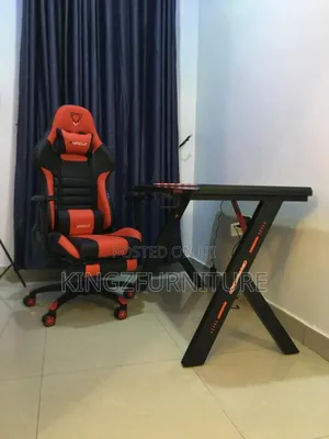 Gaming Chair With an Integrated Footrest and Black Gaming Desk.