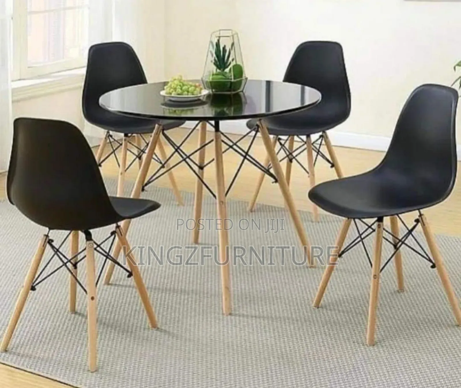 Dining Table Set With Four Black Plastic Chairs/ a Circular Table Top