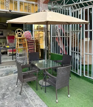 Patio Chairs, a Glass-Topped Table and an Umbrella