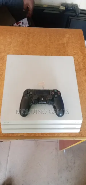 U K Used Sony Playstation 4 Pro With Two Pads and 10 Games Inside