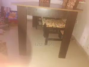 A Six Seater Coffee Color Dining Table