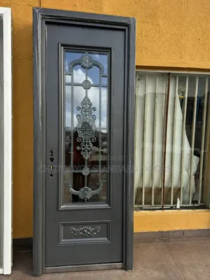 French Security Door With Intricate Wrought Iron Design On Glass Panel