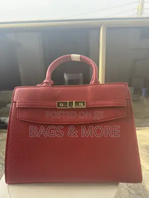 A Stylish Red Bag With Gold Accents