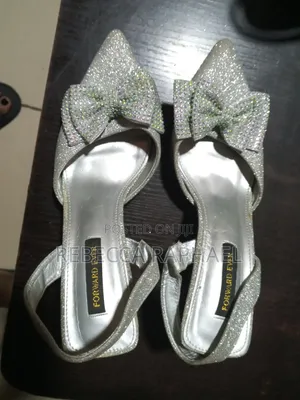 Fairly Used Silver Slingback With Stilleto Heels And Bow Details